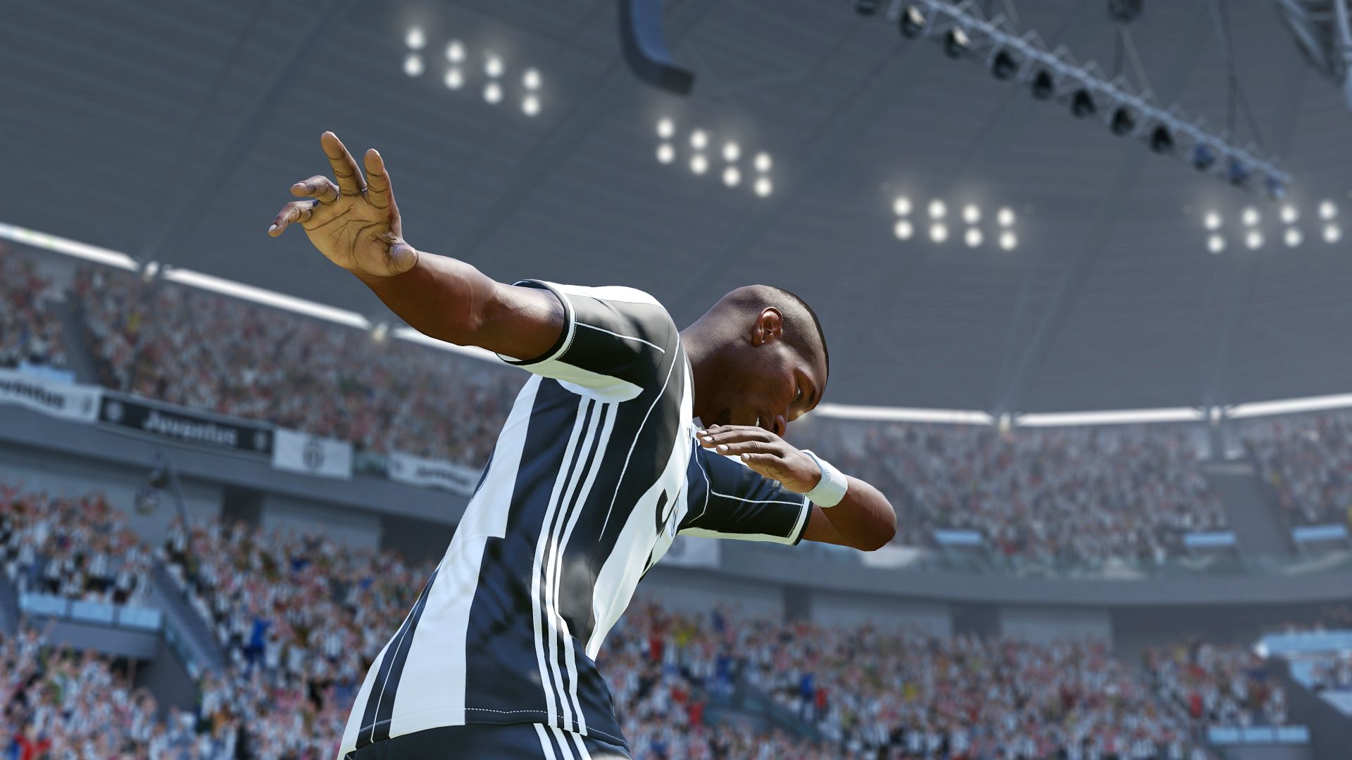 Football computer game depicting a player celebrating by striking a pose while wearing a black and white uniform.